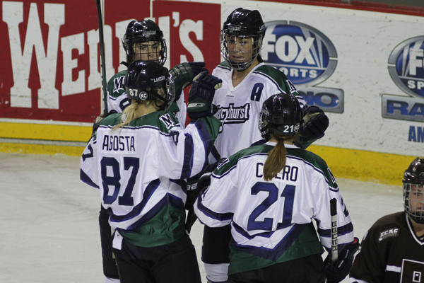 Photo by Ethan Magoc/The Merciad: Mercyhurst College's Meghan Agosta, Melissa Lacroix, Jesse Scanzano and Christie Cicero celebrate Cicero's goal in the first period on Friday, Jan. 14, 2011 at Tullio Arena.